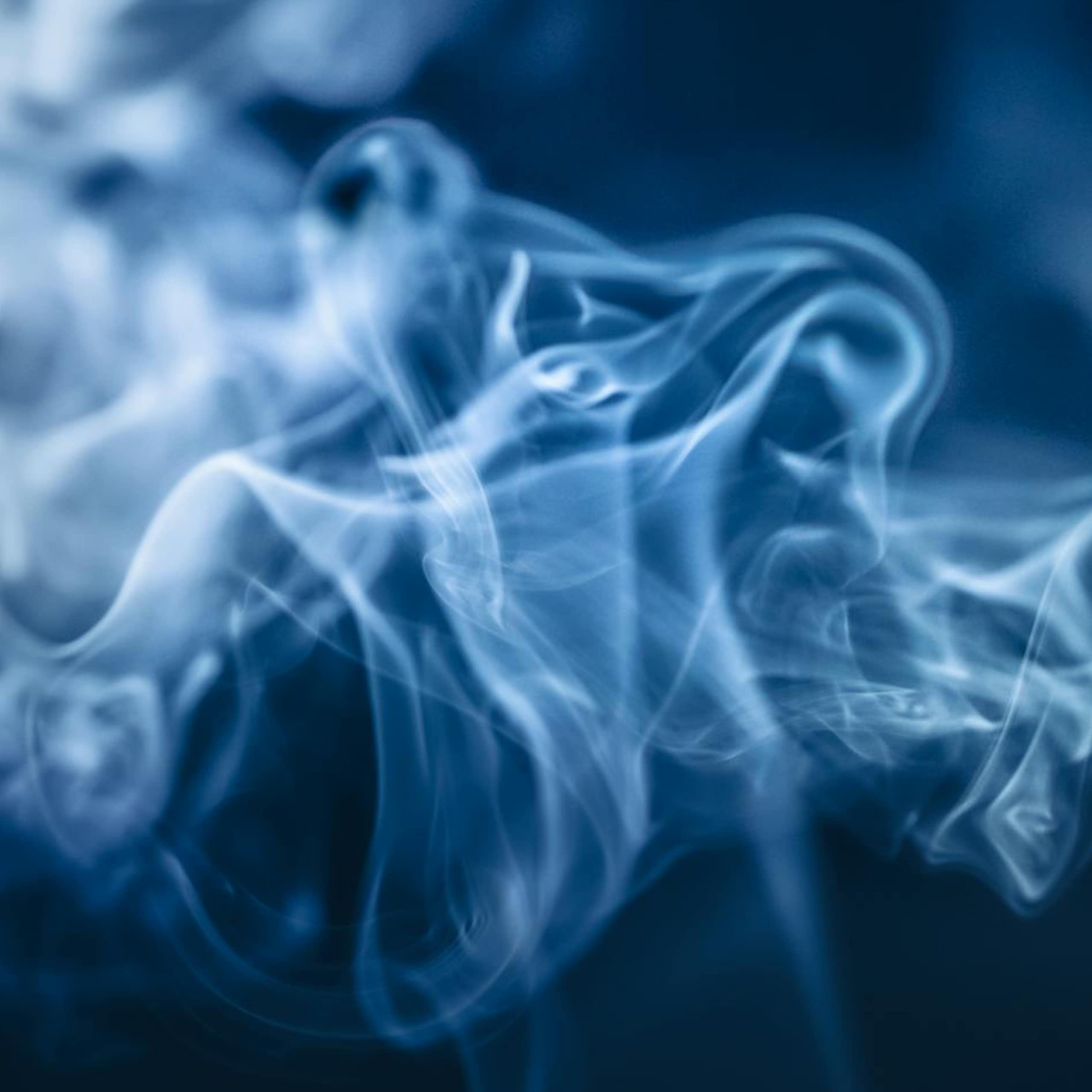 White smoke against dark blue/black background