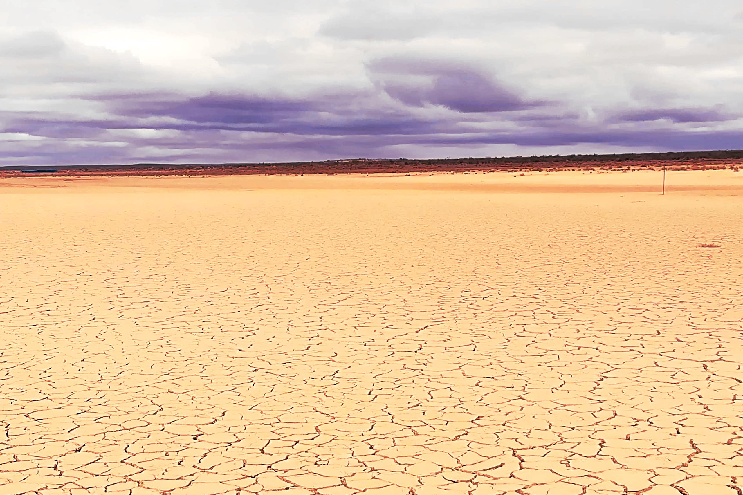 Parched and cracked brown landscape with not a single plant, stretching for miles