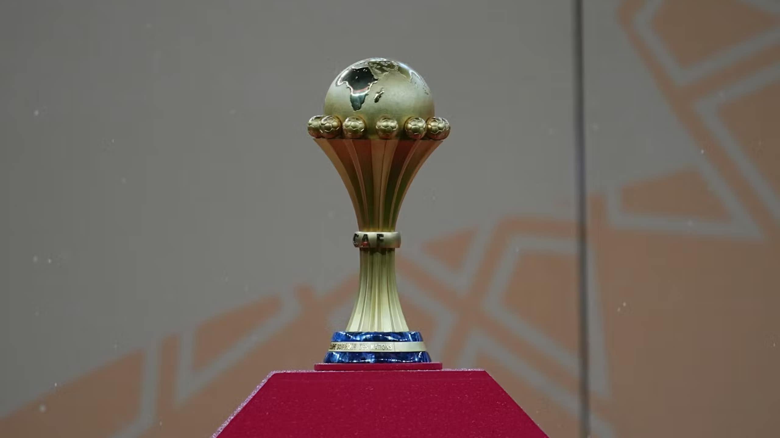 A football trophy featuring a globe cradled with the map of Africa prominent.