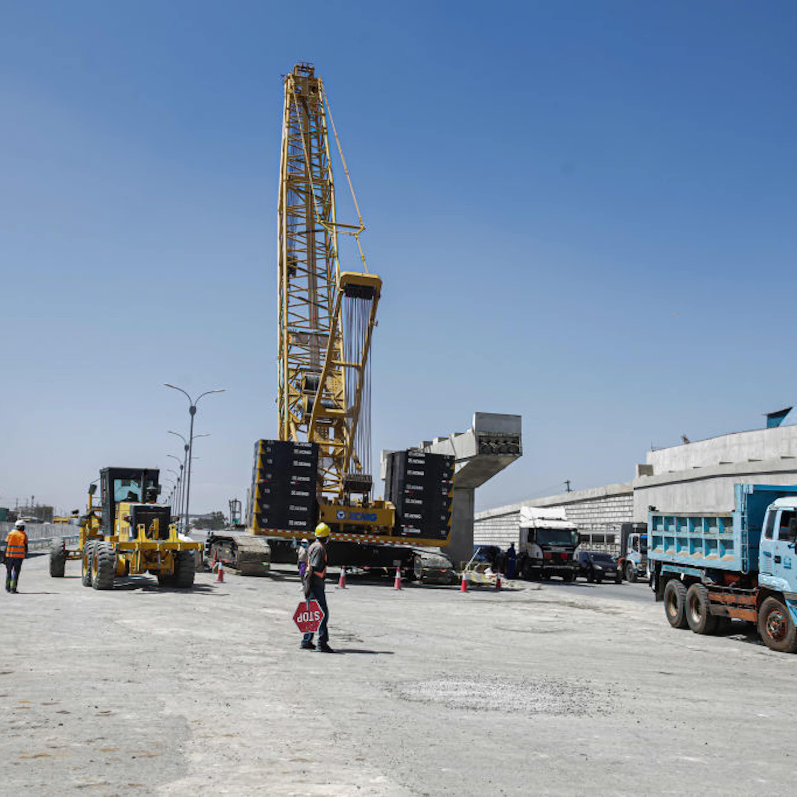 A worker helps direct traffic at a road construction site