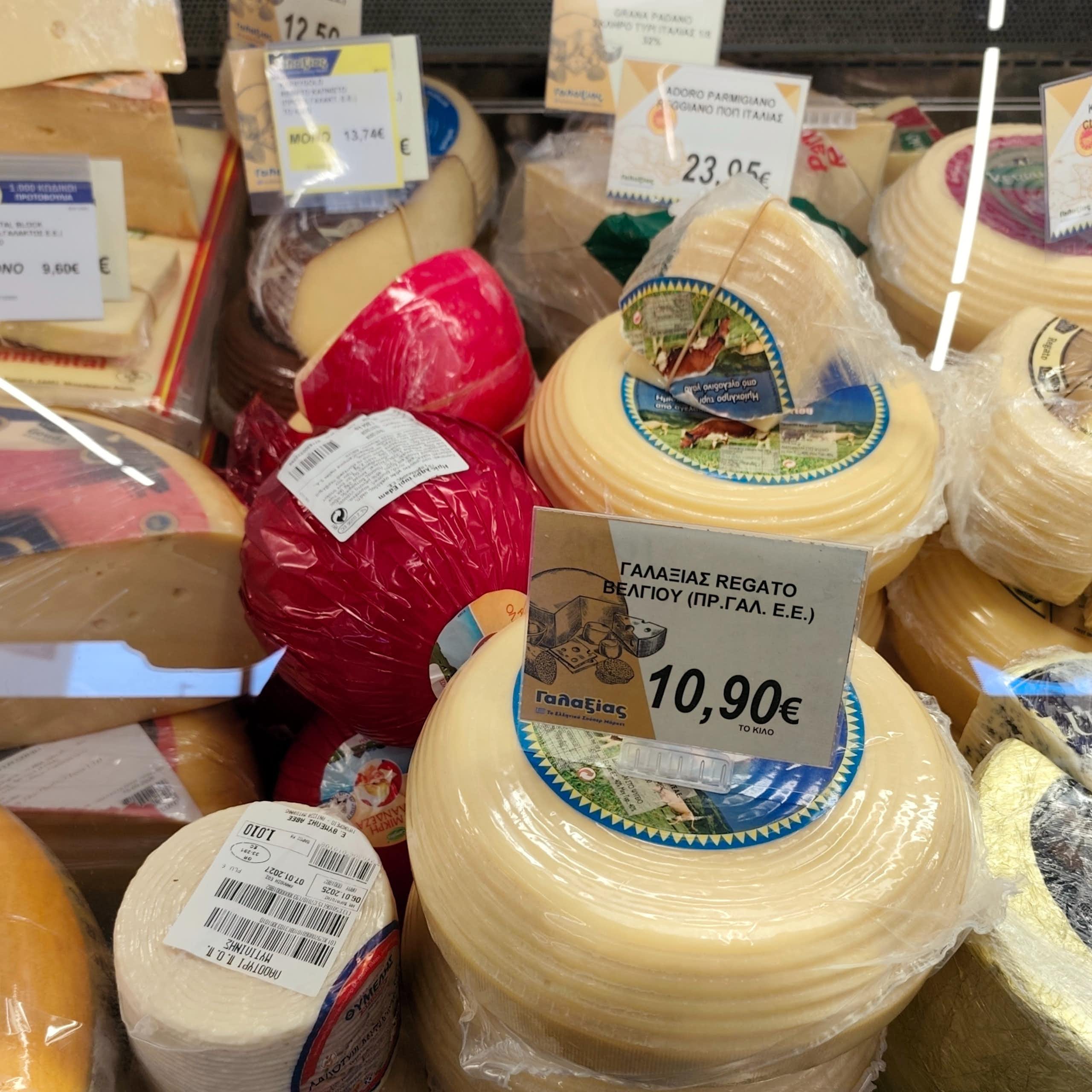 selection of cheeses on a deli counter at a greek supermarket