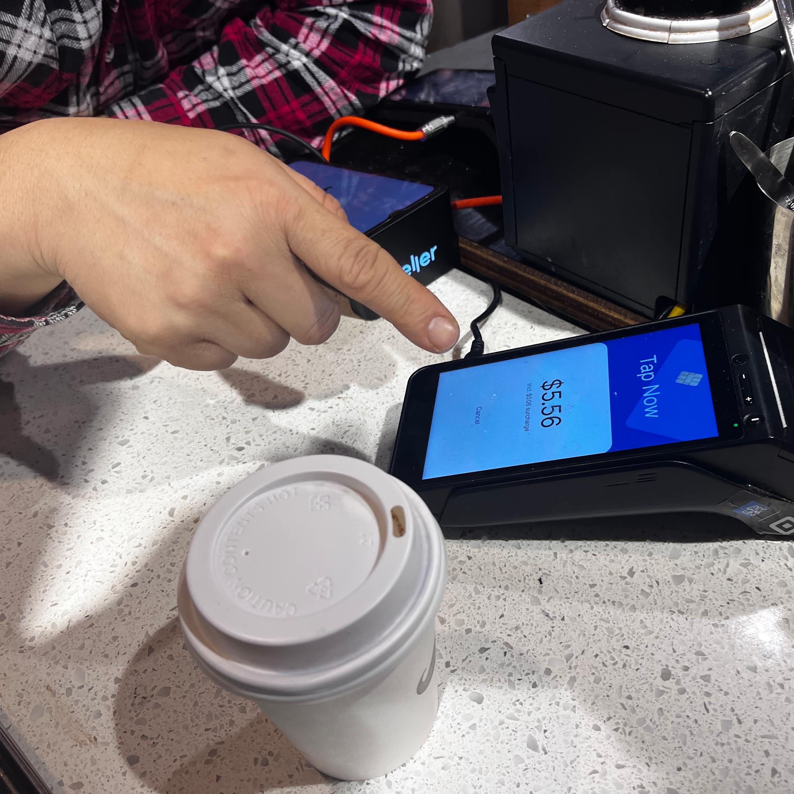 Someone about to pay for a coffee at a Sydney cafe