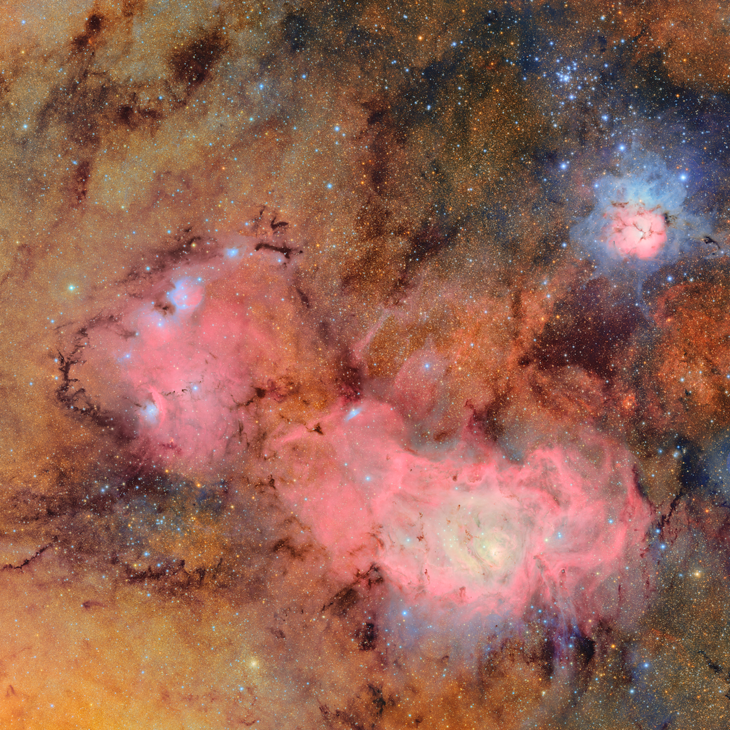 Bright clouds of pink and orange dust, surrounded by stars. 